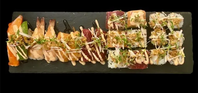 Nomadkids Combo: lange Schieferplatte mit Nigiri und Rolls, flambiert und mit Kresse